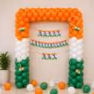Orange, white, green three-colour bunting balloon backdrop with orange, white, green balloon arch for celebrating Independence Day in an office or showroom.