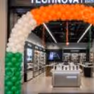 Showroom with a grand balloon arch in saffron, white and green for a national celebration.