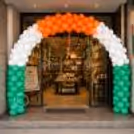 Retail showroom entrance with tricolour latex balloons and ribbon accents for a patriotic festive welcome.