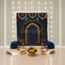 Beautiful Ganpati DIY backdrop with a peacock design along with decorative garlands and festive setup for home celebrations.