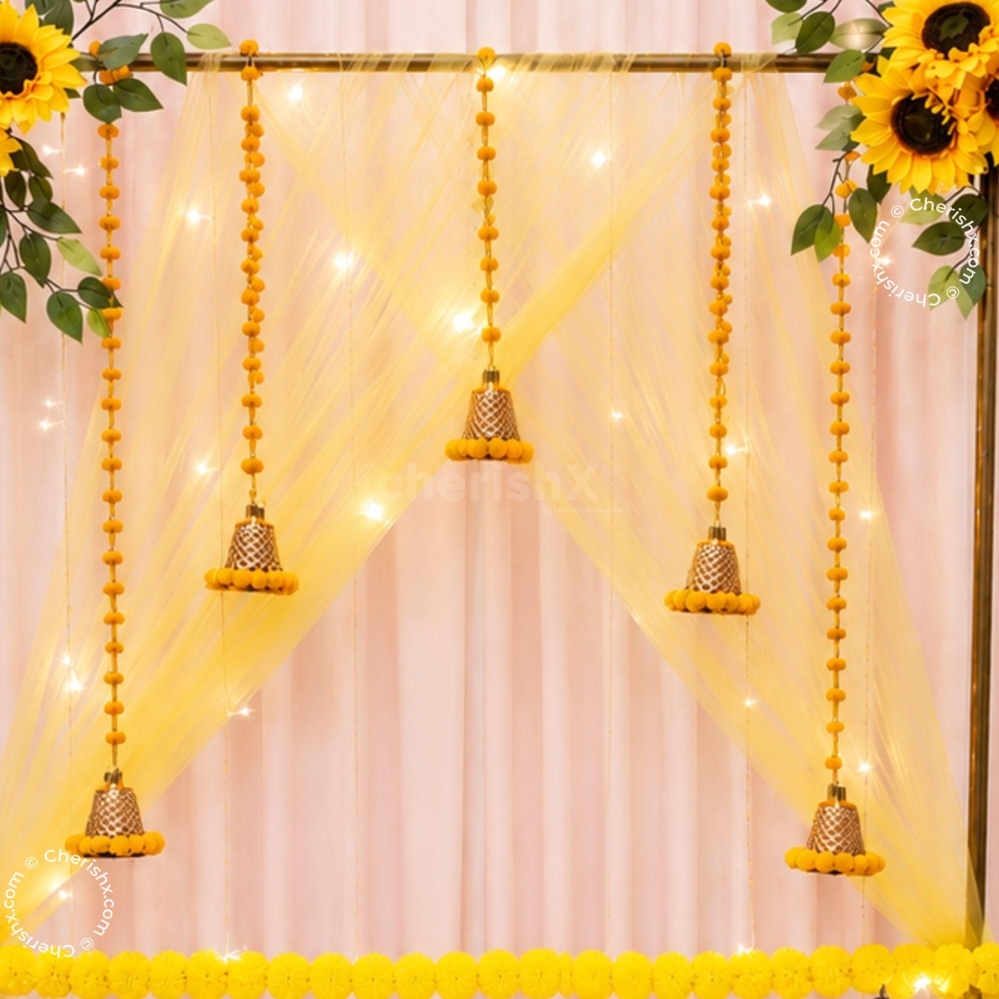 Yellow flowers, string lights and golden Ganesha Background for the installation of holiday decorations.