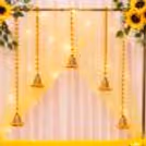 Yellow flowers, string lights and golden Ganesha Background for the installation of holiday decorations.