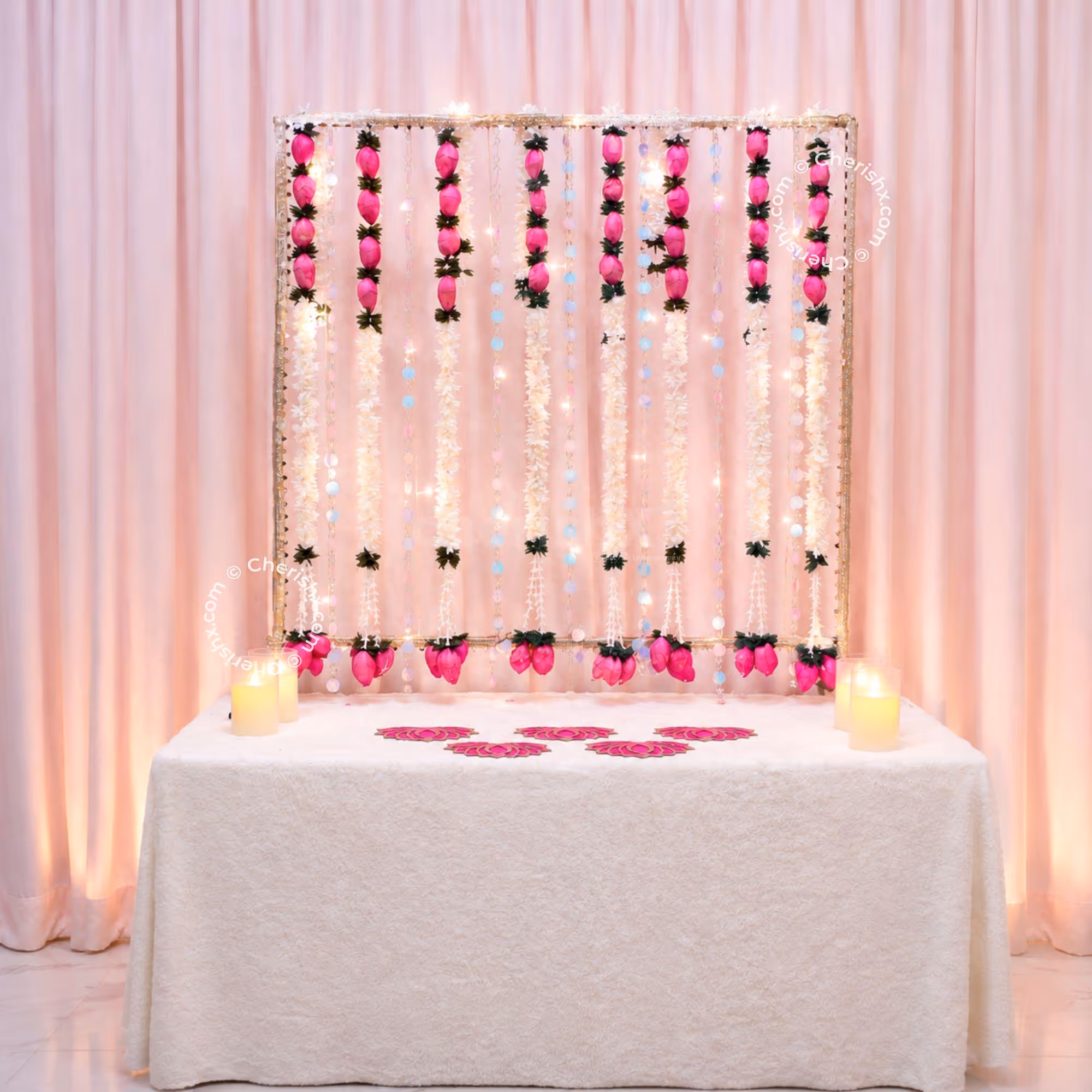 Ganpati Decoration Background with hanging Crystal Strings and Pink Florals.