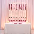 Ganpati Decoration Background with hanging Crystal Strings and Pink Florals.