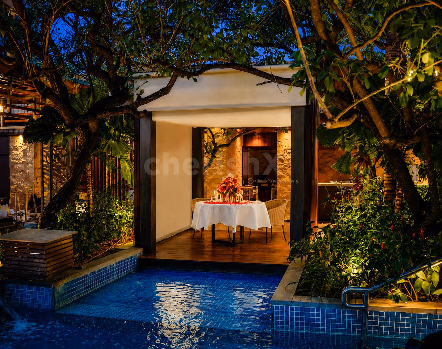 Luxury poolside dinner setup with romantic décor at Conrad Bengaluru