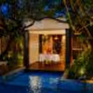 Luxury poolside dinner setup with romantic décor at Conrad Bengaluru