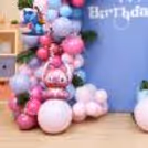 A birthday balloon decor with pink and blue balloons, a floral design and Stitch cutouts.