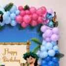 Beach Party Theme, Characters, Tropical Leaves, Balloon Clusters and Stitch Theme for a birthday event.