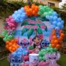 Stitch and Angel themed birthday backdrop with pastel blue, orange, green and pink balloons.