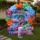 Stitch birthday decoration complete with a colourful arch, themed character cutouts and floating balloons.