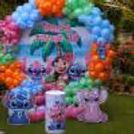 Outdoor Stitch and Angel birthday celebration with colourful balloons and a tropical theme.
