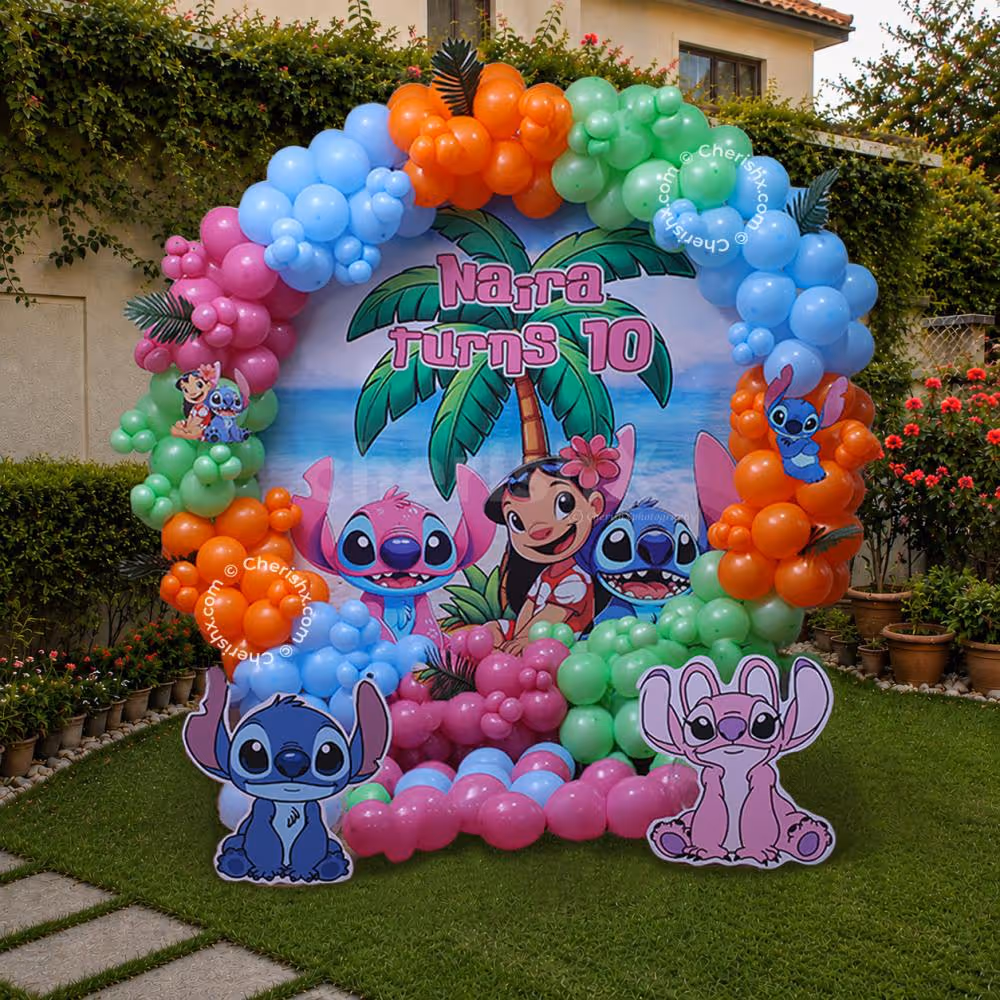 Colourful Stitch birthday decorations featuring a large balloon arch and themed backdrop in an outdoor garden setting.