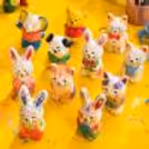 Children’s activity making figurines and painting with brushes using homemade figurines and craft materials.