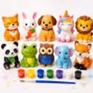 Creative kids painting figurines with paint pots, brushes, aprons and homemade figurines.
