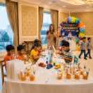 Kids creative activity with children painting and decorating small DIY figures in bright colours.