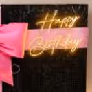 Blackpink birthday design with a black sequin background and a happy birthday neon sign.