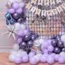 Silver Foil Frilled Curtains At The Back Of The Ring Stand Make The Birthday Decor Eye-Catching.