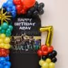 Roblox-themed kids birthday setup with golden numbers balloon, 4d star and multicolored balloons.