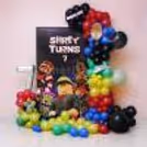 Customisable flex backdrop, colourful balloon arch and themed character cutouts for Roblox Adventure birthday decorations.
