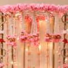 A warm Fairy light with Pearl flower hangings and Tassel garlands on the backdrop of Pearl pink Ganesh Chaturthi.