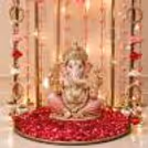Close-up of floral tassels, hanging pearls and lit decorative background for Ganesh Chaturthi.