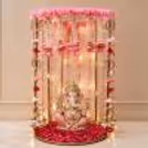 Front view of festive background with pearl decor, pink flowers, warm light and a round golden stand.