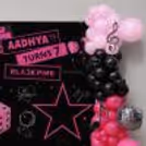 Close-up of BLACKPINK-inspired birthday setup with customised backdrop, pink balloons and silver disco foil balloon.