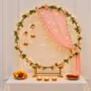 A peach draped with warm fairy lights, surrounded by green leaves and yellow blossoms.