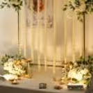 Ganpati idols with white jasmine strings on a golden background