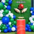 Customised Cricket Birthday flex and sporty party details with a green and White balloon setup