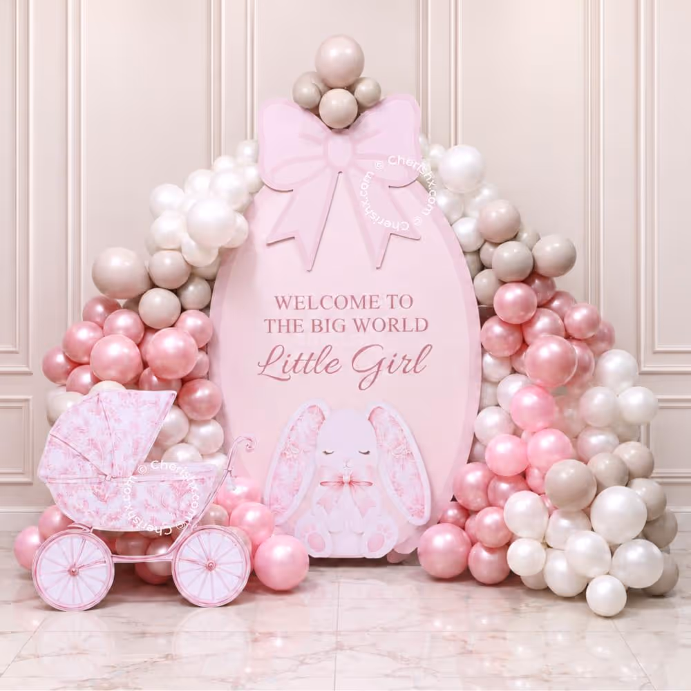 Welcome Baby Vintage Blush Balloon Decoration with a big pink baby girl backdrop and balloon arch.