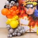 A bold Naruto flex wall with a vibrant anime balloon arch.