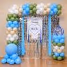 Elegant name revealing backdrop with soft pastel balloons