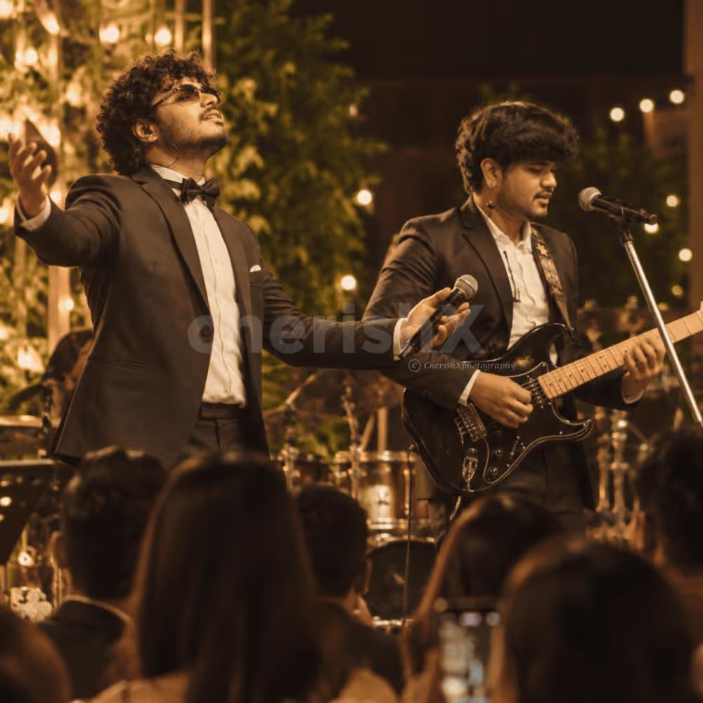 Live music duo performing together with a singer and guitarist at an evening event.