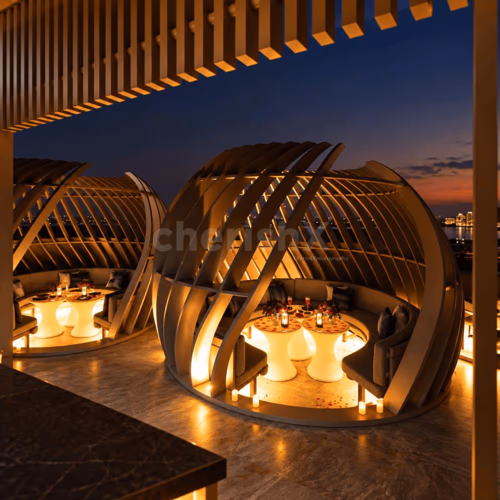 Private rooftop gazebo dining experience for couples with intimate seating, warm lighting and beautifully decorated tables.