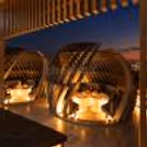 Private rooftop gazebo dining experience for couples with intimate seating, warm lighting and beautifully decorated tables.