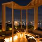 Intimate rooftop dining experience featuring rose bouquets, candlelight, mocktails and a romantic evening ambience.