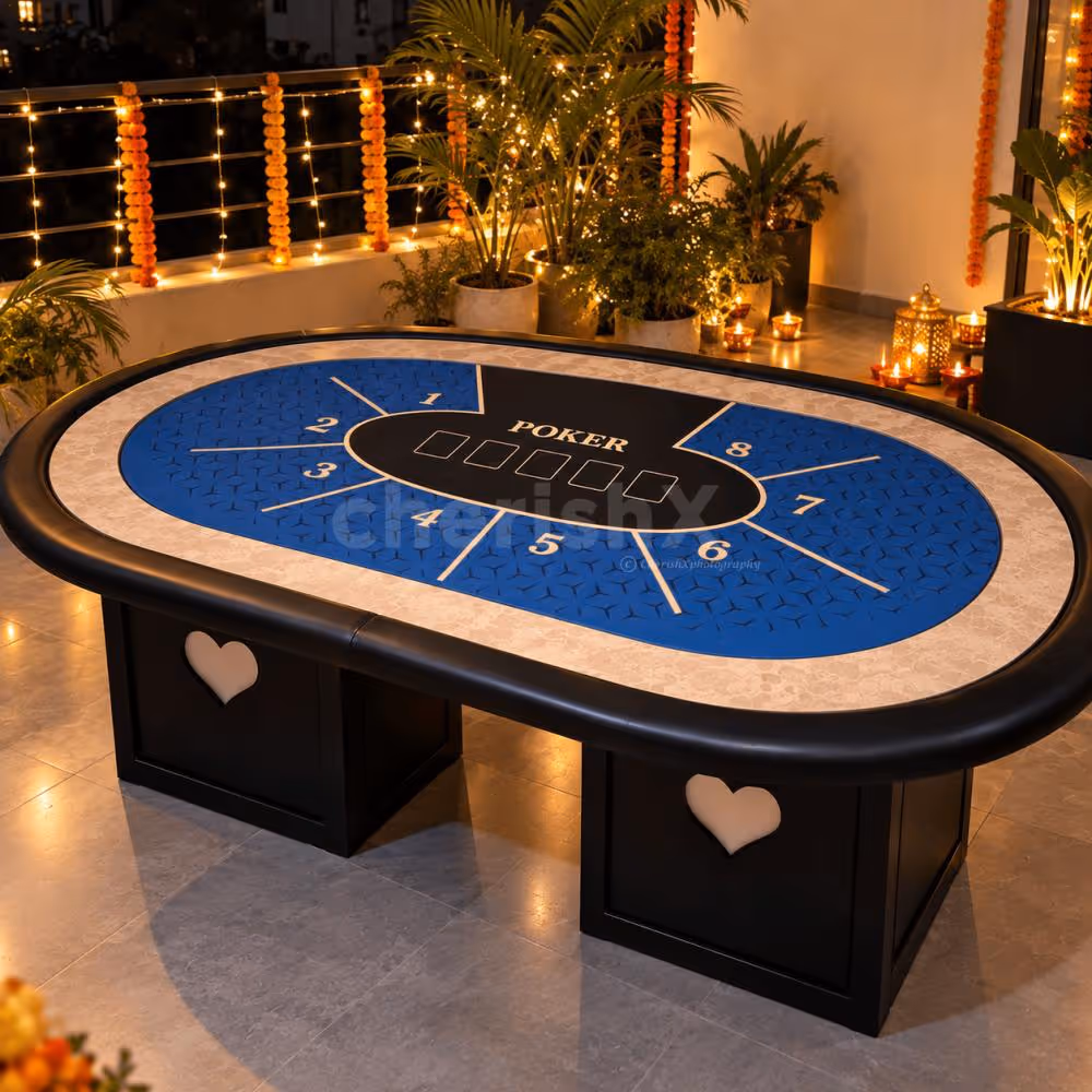 Blue poker table setup on a terrace decorated with warm Diwali lights, marigold garlands and diyas.