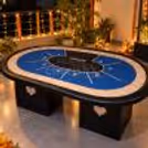 Blue poker table setup on a terrace decorated with warm Diwali lights, marigold garlands and diyas.