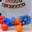 Decorate with kids racing car cutouts and multicolored setups of balloons.
