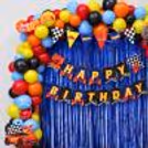 Racing Theme Birthday Decoration With Hot Wheels Bunting, Car Cutouts And Colourful Balloon Arrangement.