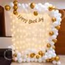 White and Gold Birthday Decoration with Balloon Arch, Fairy Light Backdrop and Happy Birthday Banner – Elegant Birthday Party Setup for Home Celebrations.
