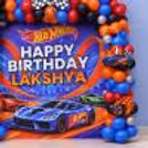 Children's Theme Birthday Decor with Hot Wheels Cars and a colourful balloon arrangement.