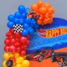 Hot Wheels Birthday Balloon Setup with Car Foil Balloon, Checkered Racing Flags and Birthday Backdrop.