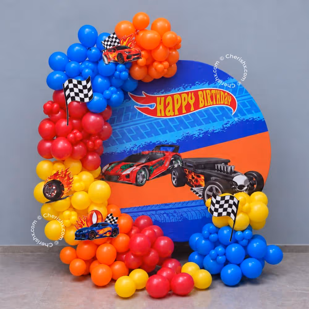Hot Wheels celebrates the occasion of a birthday with colourful racing car balloon decorations and a personalised flex backdrop.