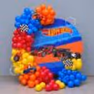 Hot Wheels celebrates the occasion of a birthday with colourful racing car balloon decorations and a personalised flex backdrop.