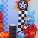 Hot Wheels racing party setup with a colorful balloon arch