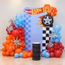 Fun racing theme celebration with floating balloons and flags