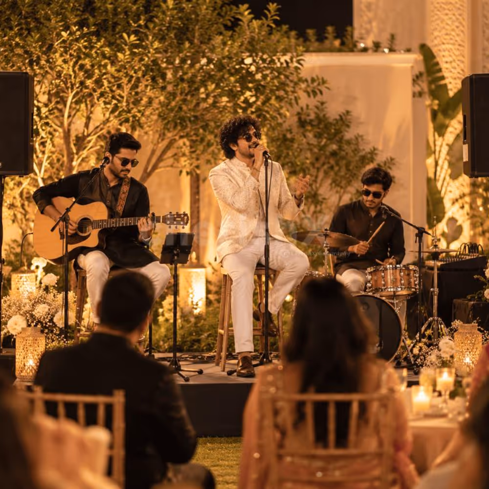 Live band entertaining guests at an elegant evening event with warm lights, floral décor and a festive atmosphere.