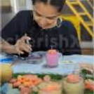 hands-on wax candle-making experience, crafting personalised candles with wax, wicks and floral decorations.